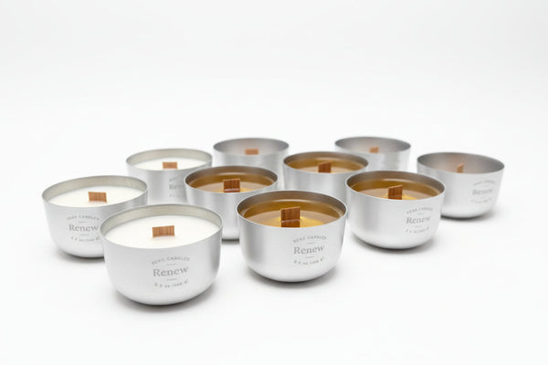 Nine Sero aluminum candles with wood wicks, showing colour differences between fragrance formulations.