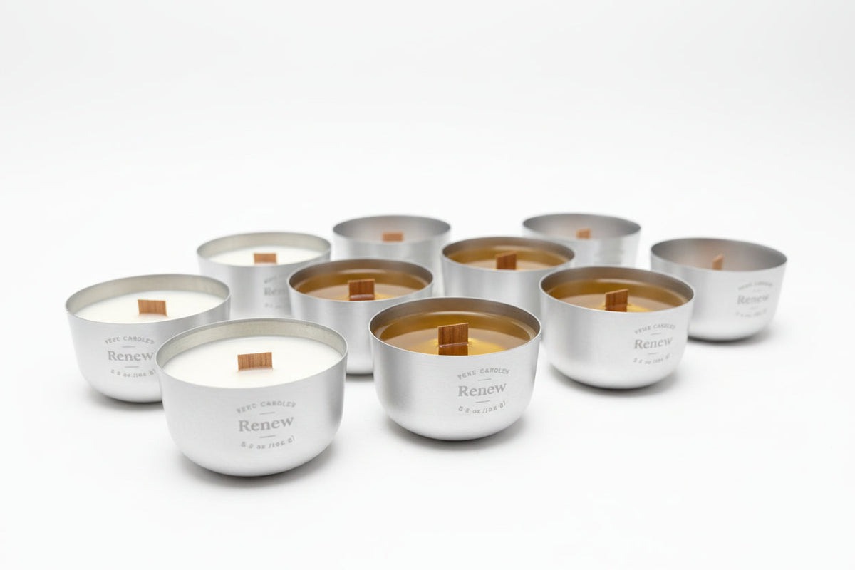 Nine Sero aluminum candles with wood wicks, showing colour differences between fragrance formulations.
